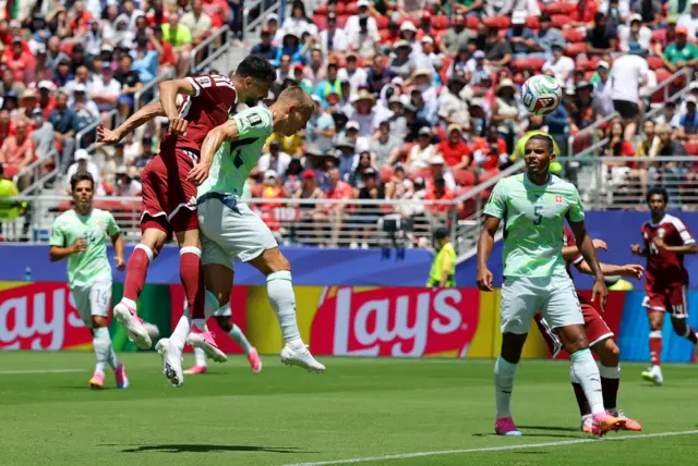 Qatar's Boualem Khoukhi scores their first goal
