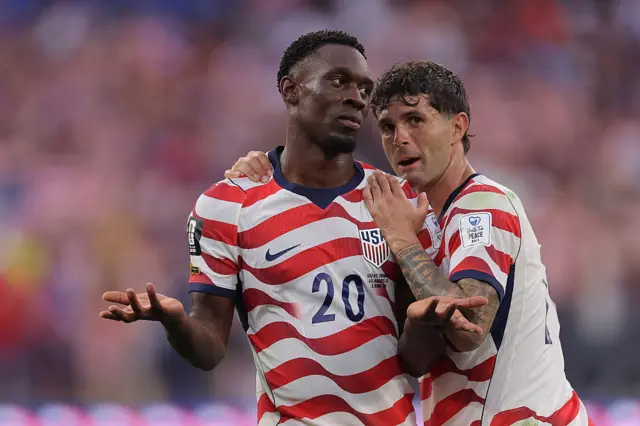 Folarin Balogun holds out his arms and is hugged by Christian Pulisic