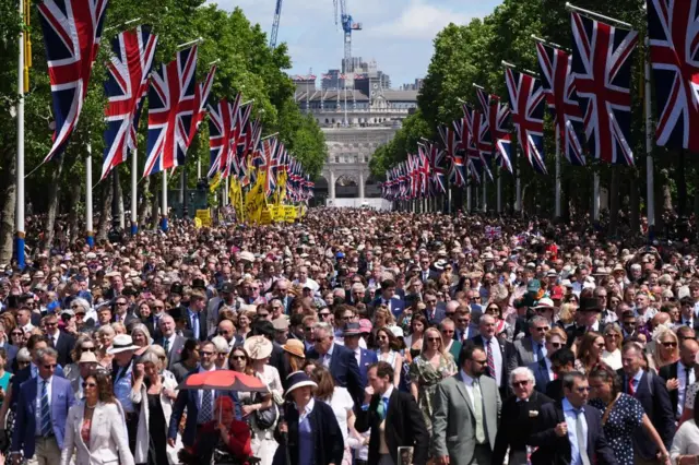 Crowds gather outside Buckingham Palace to get a glimpse of the Royal Family appear on the palace balcony.