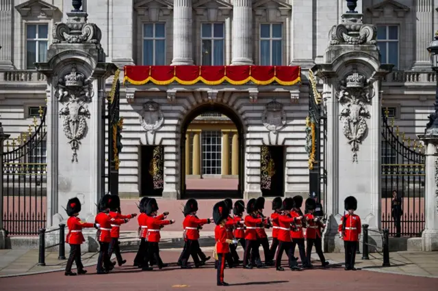 Members of the Household Division march outside Buckingham Palace.