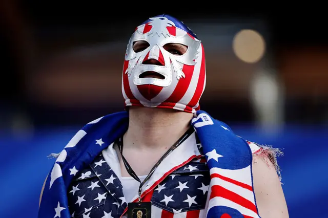 A person wearing an American flag branded mask and jacket
