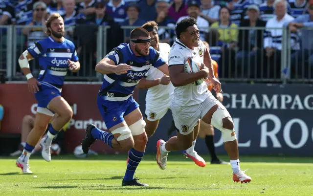 Greg Fisilau of Exeter Chiefs is chased down by Josh Bayliss