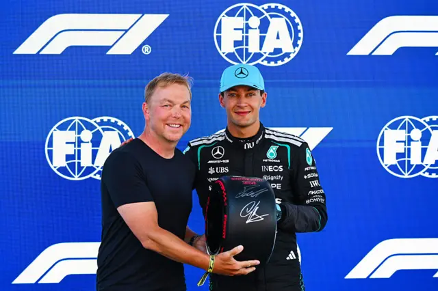 George Russell received his pole position award from Sir Chris Hoy