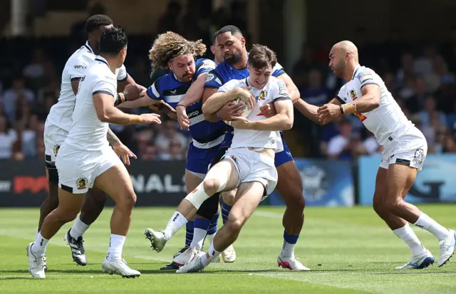 Campbell Ridl of Exeter Chiefs is held by Joe Cokanasiga