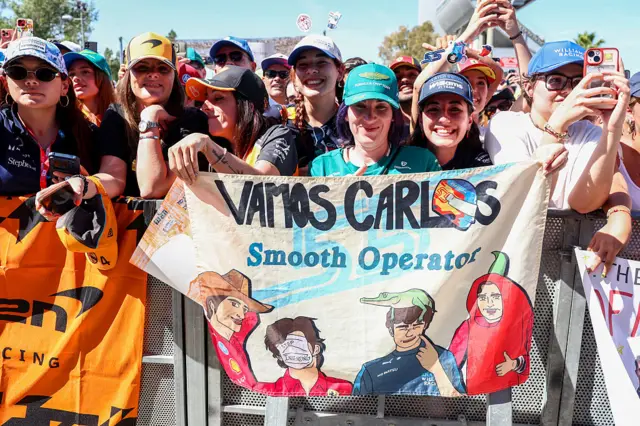 Fans hold up signs for Carlos Sainz