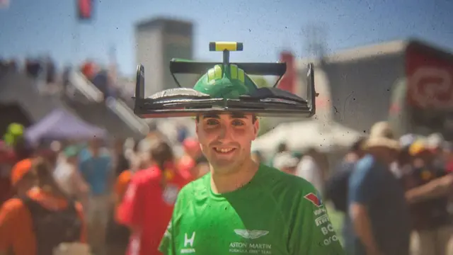 fan with an aston martin car hat