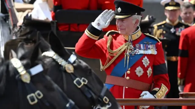 King Charles III salutes during the Trooping the Colour ceremony on 14 June 2025