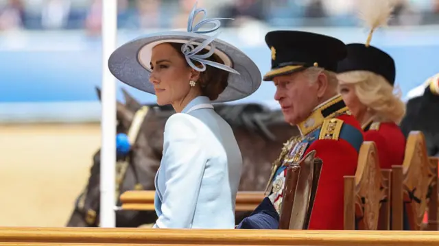 Princess Catherine sits beside the King and Queen.