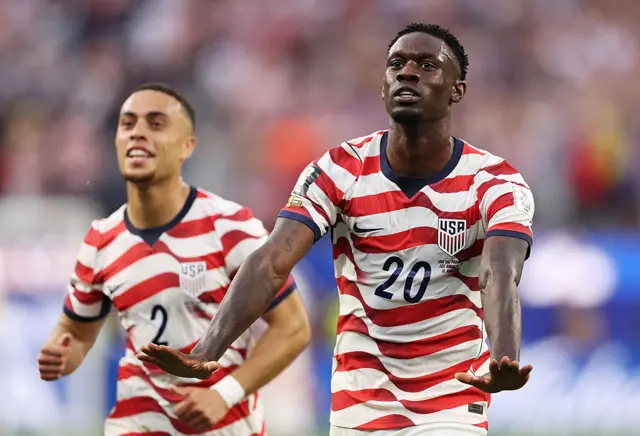 Folarin Balogun holds out his arms to celebrate