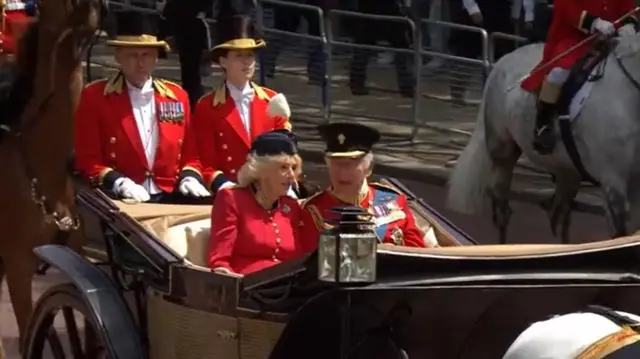 King Charles and Queen Camilla travel in a carriage back to Buckingham Palace