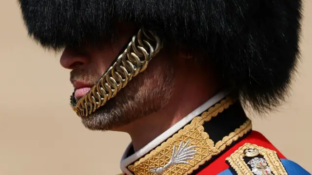 A close up photo shows the Prince of Wales wearing his military attire and bearskin hat during the Trooping the Colour