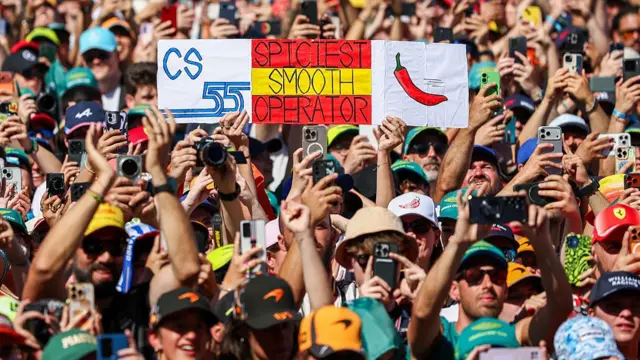 fans holding Carlos Sainz banner