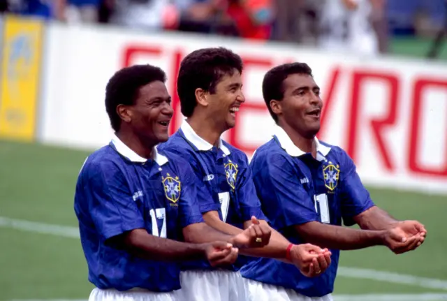 Brazil players mimic rocking a baby