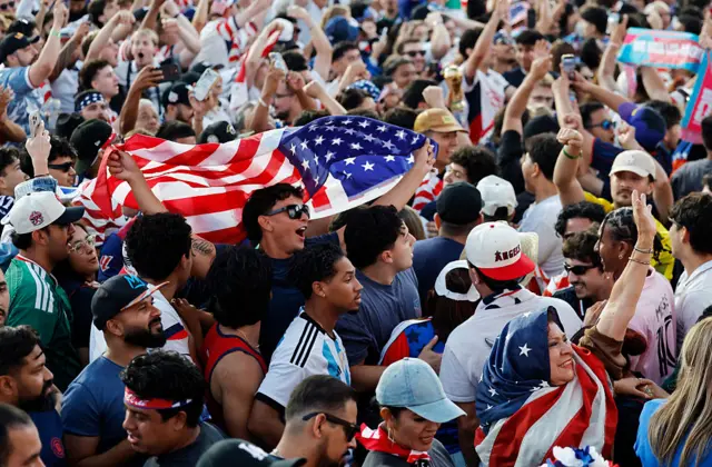A crowd of people with the American flag