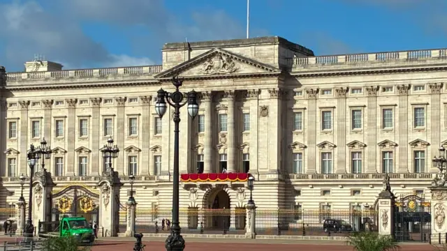 Buckingham Palace's balcony is draped in red ahead of the flypast later.