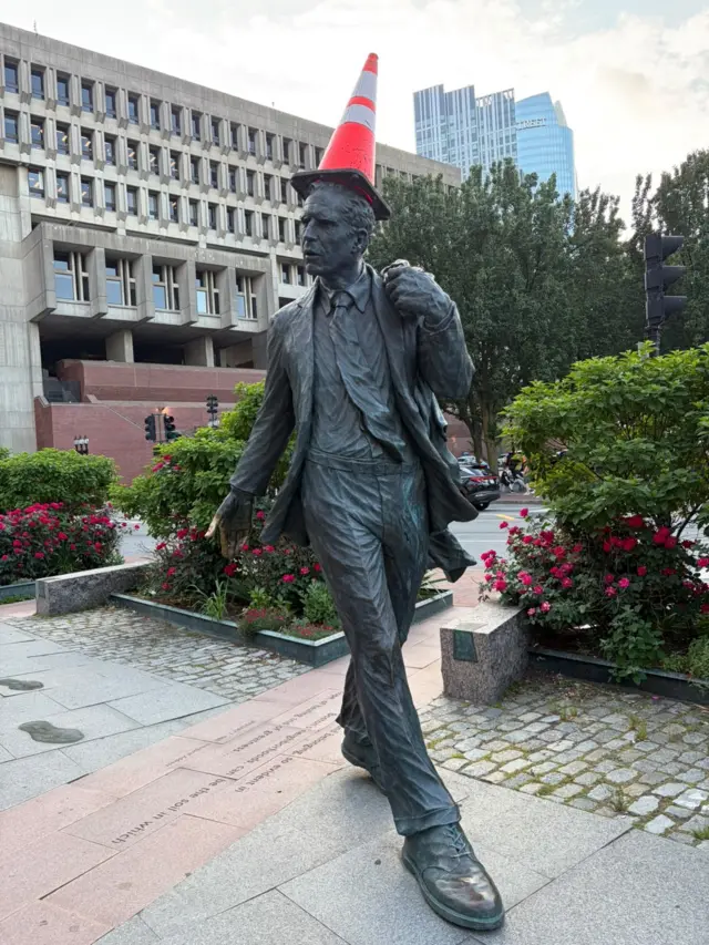 Statue in Boston with a police cone on its head