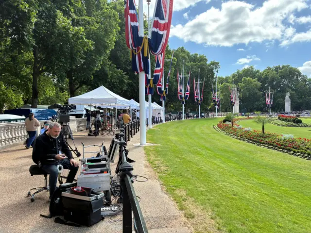 Media are set up under tents to shield from the sun near Buckingham Palace.