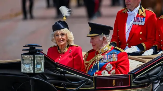 King Charles and Queen Camilla travel back in their carriage to Buckingham Palace along the Mall