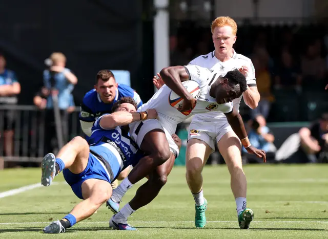 Paul Brown-Bampoe of Exeter Chiefs is held by Henry Arundell