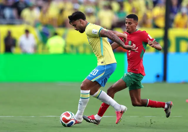 Lucas Paqueta is challenged by Azzedine Ounahi