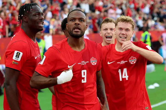 Cyle Larin celebrates with his Canada team-mates