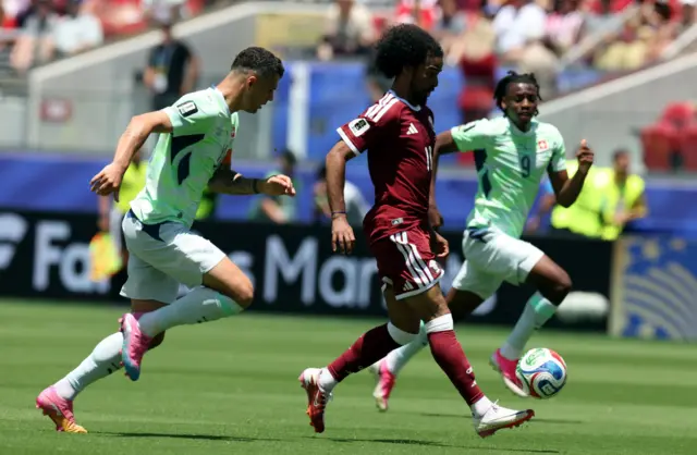 Granit Xhaka of Switzerland (L) and Akram Afif of Qatar in action during the FIFA World Cup 2026 group stage match Qatar against Switzerland