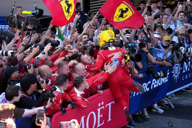 Lewis Hamilton jumps into his ferrari crew after winning in Barcelona