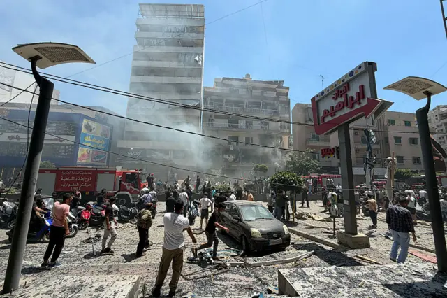 People gather at the site of an Israeli airstrike that targeted a building in Beirut's southern suburbs on June 14, 2026