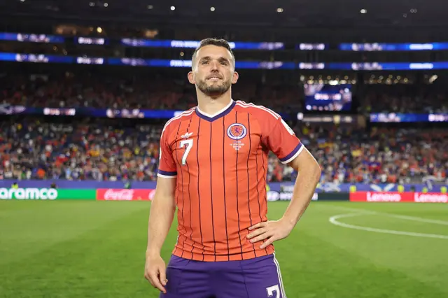 John McGinn places his hand on his hip
