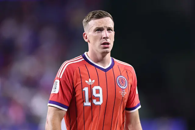 Lewis Ferguson wearing a red Scotland shirt