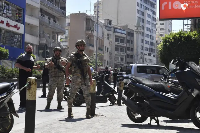 Security forces and emergency responders inspect the site after an Israeli airstrike hit Beirut's southern suburb of Dahiye despite an existing ceasefire, in Beirut, Lebanon