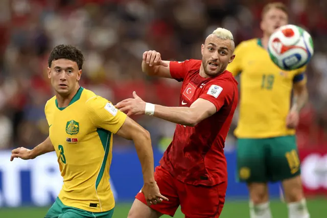 Baris Alper Yilmaz #21 of Turkiye and Alessandro Circati #3 of Australia compete for the ball during the FIFA World Cup 2026 Group D match between Australia and Türkiye at BC Place Vancouver