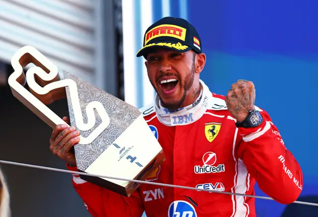 Lewis Hamilton celebrates on the podium