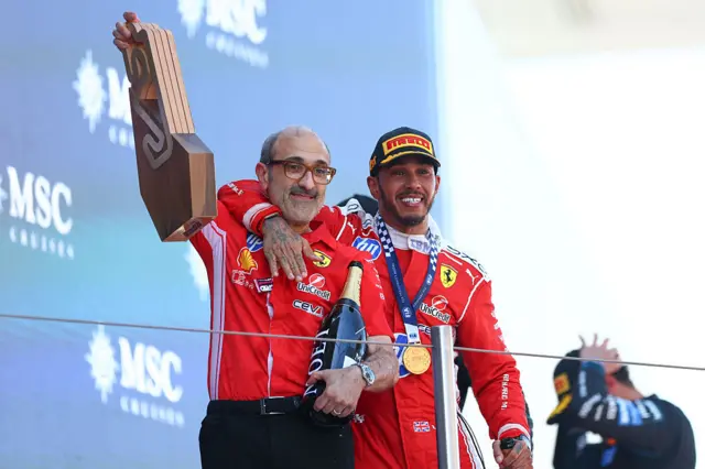 Carlo Santi and Lewis Hamilton celebrate on the podium