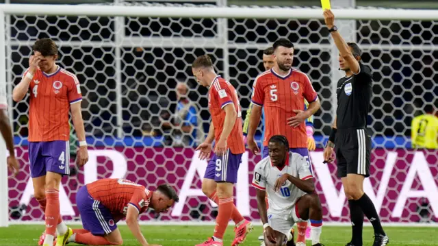 Jean-Ricner Bellegarde is shown a yellow card for Haiti