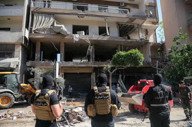 Lebanese army soldiers stand guard as people clear the rubble at the site of an Israeli airstrike that targeted a building in Beirut's southern suburbs on June 14, 2026. The office of Israeli Prime Minister Benjamin Netanyahu said on June 14 the military had carried out strikes in Beirut's southern suburbs, known as Dahiyeh