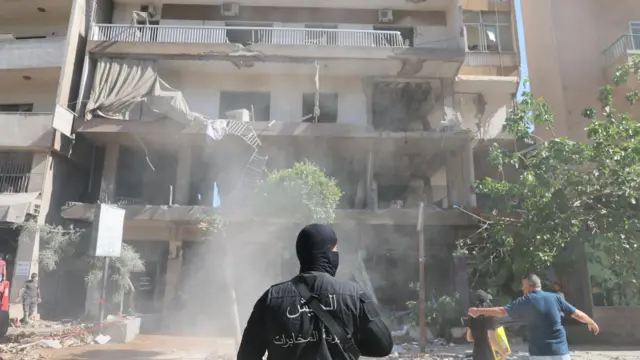 A Lebanese security serviceman stands near the site of an apartment targeted by an Israeli airstrike in Beirut's southern suburbs, Lebanon, 14 June 2026