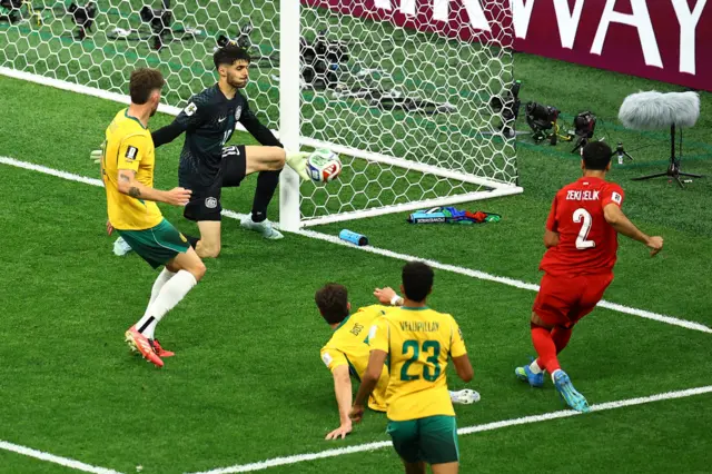 Turkey's Zeki Celik has his shot saved by Australia's Patrick Beach