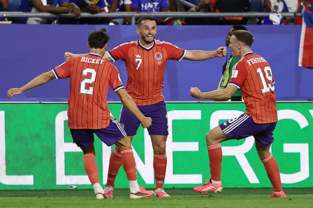 John McGinn, Lewis Ferguson and Aaron Hickey celebrate