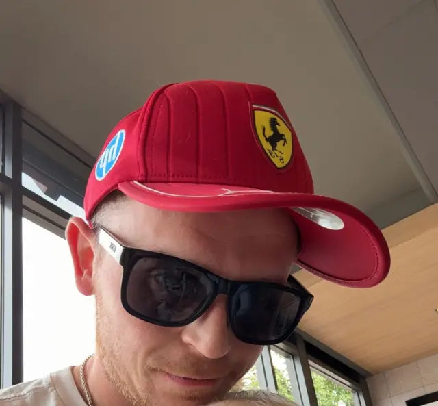 Man in red Ferrari hat