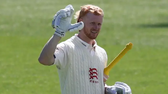 Essex batter Jordan Cox waves to the crowd after bringing up a century against Leicestershire