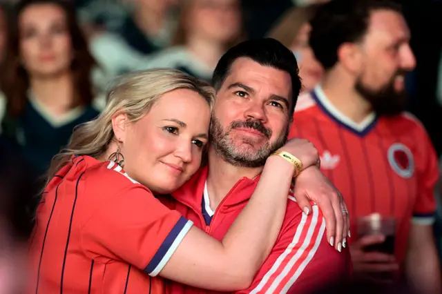 A man and woman hug