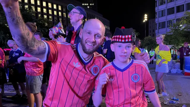 A man and boy wearing Scotland tops