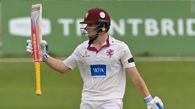Thomas Rew rasies his bat for 50