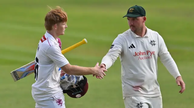 Thomas Rew shakes hands with the Notts fielders