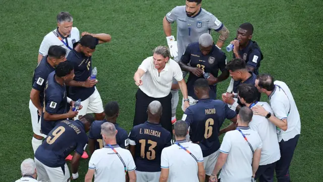 Head Coach of Ecuador, gives players instruction at the hydration break