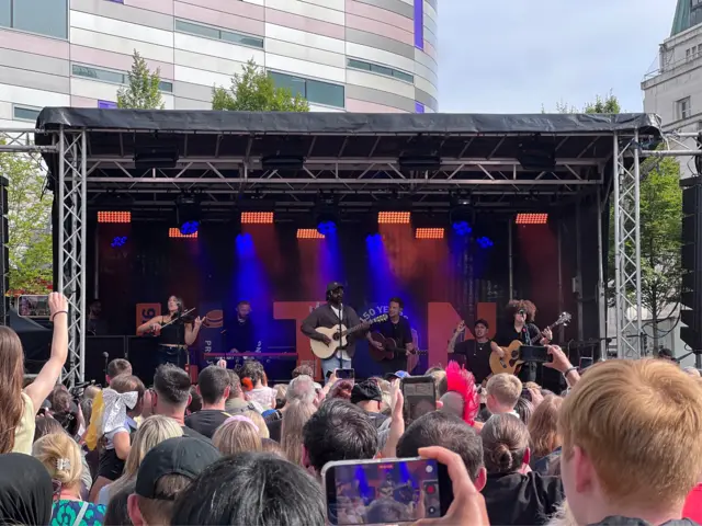 Myles Smith is onn stage with a huge crowd gathered in front of him