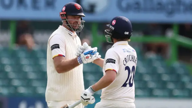 Paul Walter is congratulated by Matt Critchley having scored 100 while batting for Essex