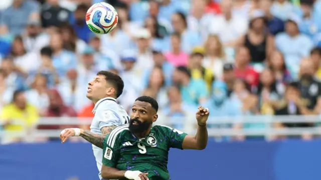 Mathias Olivera and Feras Al-Brikan fight for the ball