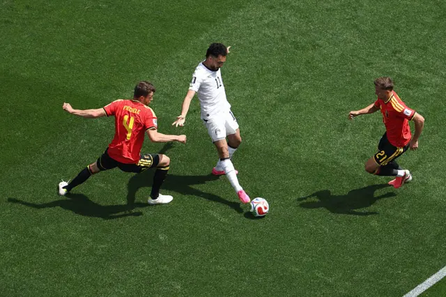 Mostafa Zico controls the ball under pressure from Brandon Mechele and Timothy Castagne